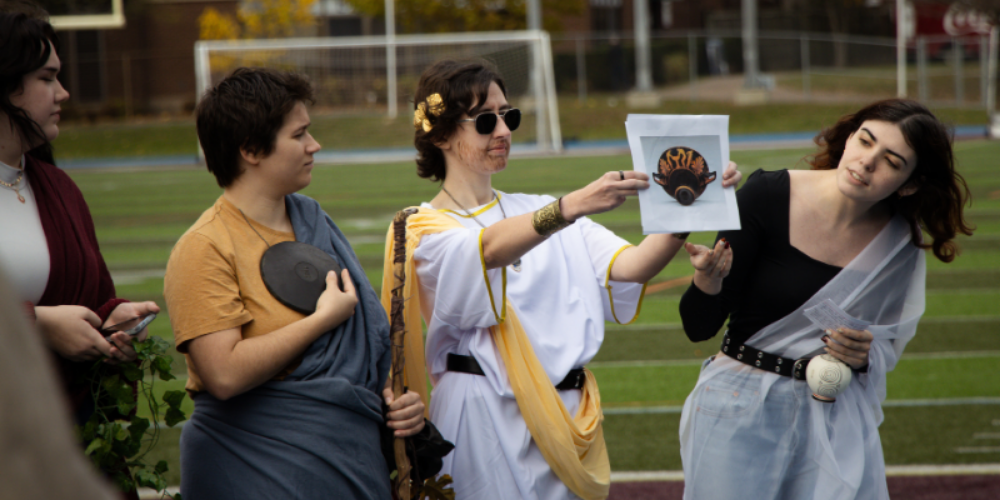 Students dressed in togas and costumes during an ancient olympics demonstration