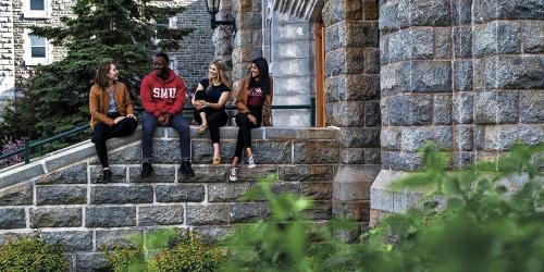 Students sitting near stairs